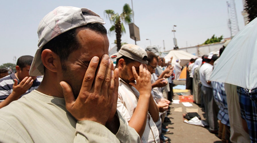 Dozens killed in clash outside military building in Cairo