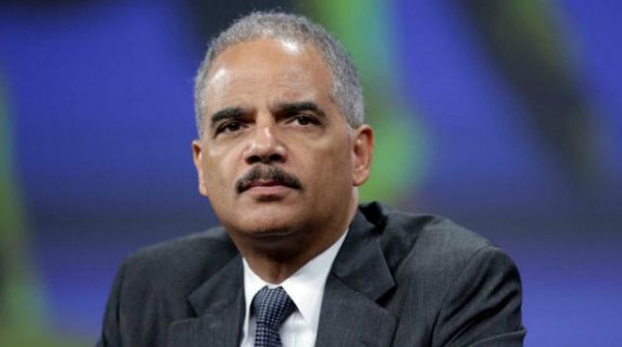 Holder claims racial hostility drives critics of White House