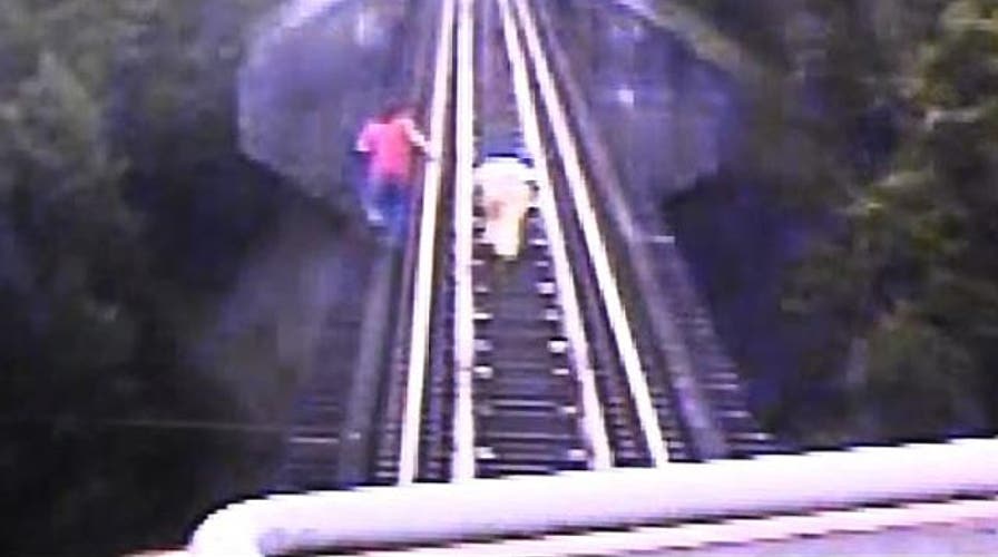 Raw video: Women flee approaching freight train