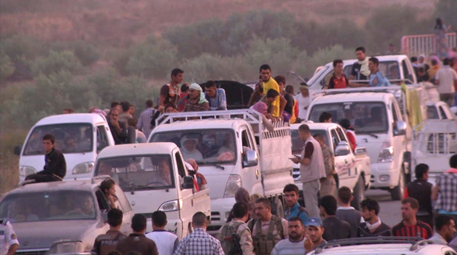 Thousands flee after ISIS militants seize towns in Iraq