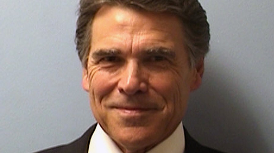 Perry booked on abuse of power charges, vows to 'prevail'