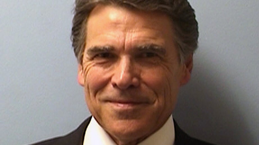 Perry booked on abuse of power charges, vows to 'prevail'