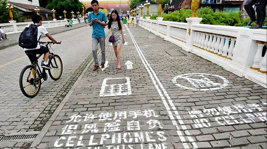 Chinese city creates sidewalk lane for people on phones