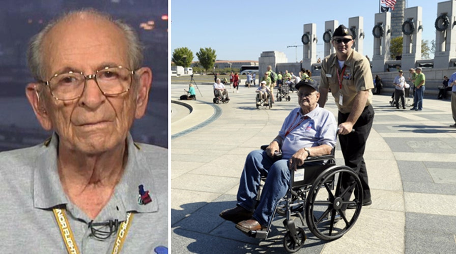 WWII veterans break down barricades at WWII memorial