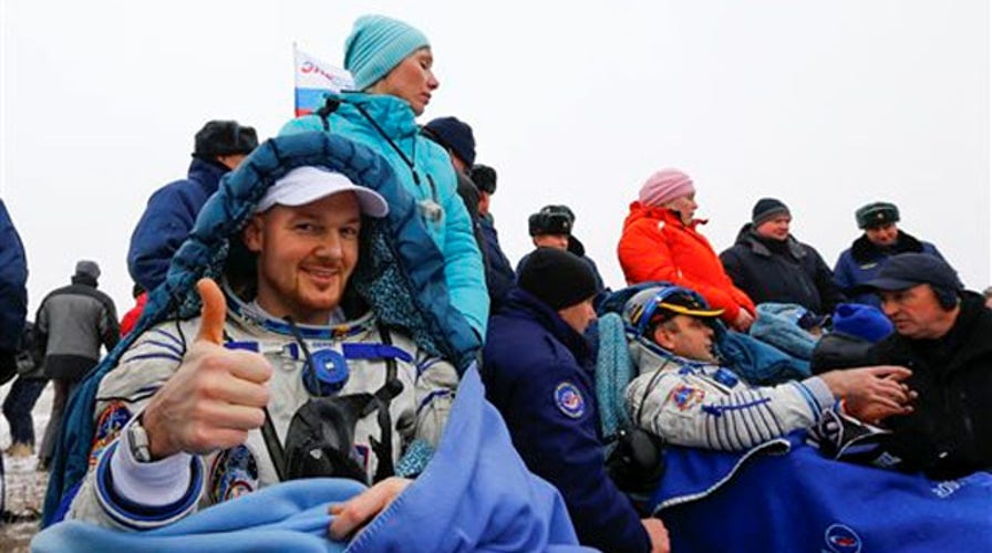 International Space Station crew members return to Earth