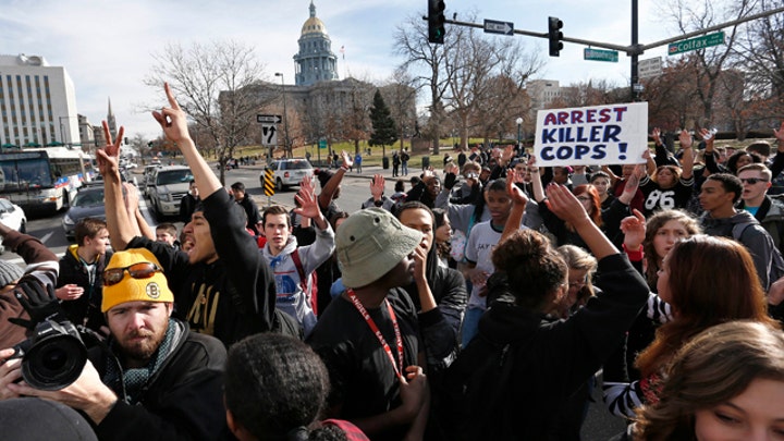 Four Denver officers hit by car during Ferguson protest