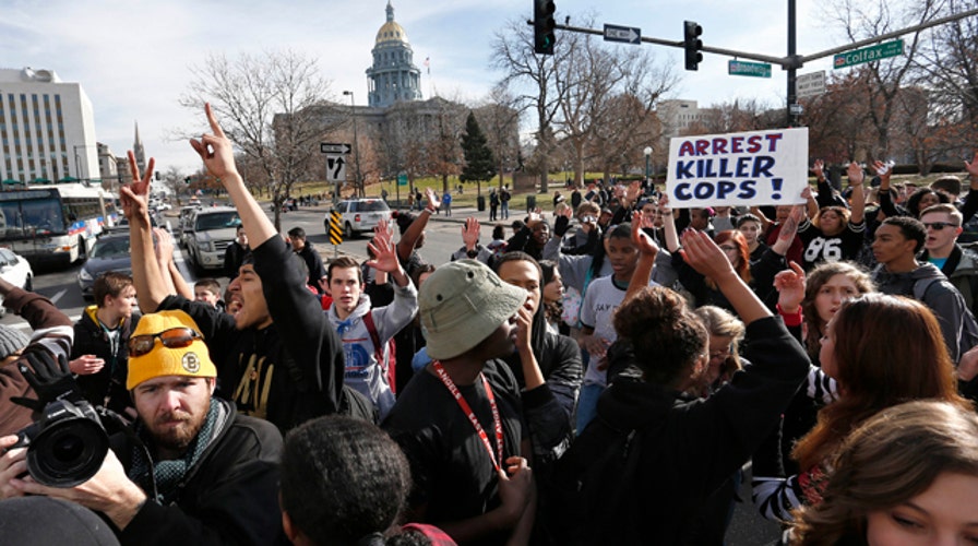 Four Denver officers hit by car during Ferguson protest