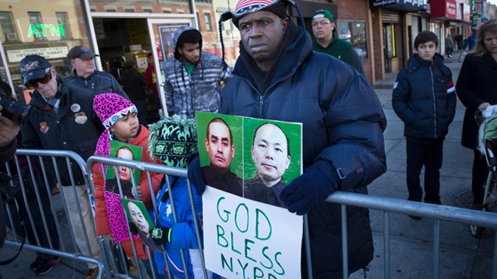 New threats emerge as slain NYPD officer is remembered