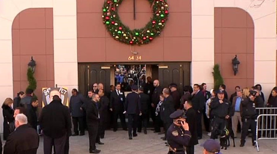 Thousands gather outside the funeral for Rafael Ramos