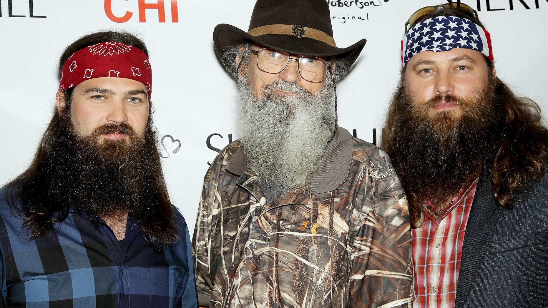 This image released by Starpix shows TV personalities,from left, Jep Robertson, Si Robertson, and Willie Robertson, from the A&E series "Duck Dynasty," at the Sherri Hill Fashion Show, Monday, Sept. 9, 2013, in New York. The Robertsons attended to support Willie's daughter Sadie Robertson who modeled several outfits for the show. (AP Photo/Starpix, Marion Curtis)