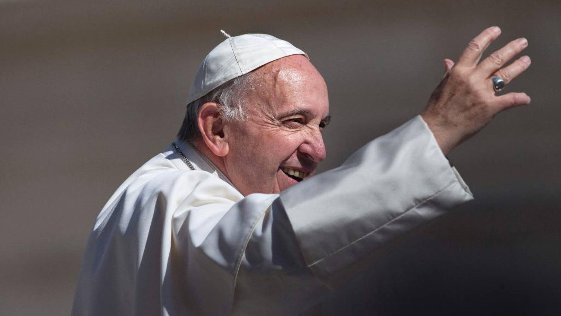 Pope Francis waves to the crowd as he arrives for his weekly general audience in St. Peter's Square at the Vatican, Wednesday, May 18, 2016. (AP Photo/Alessandra Tarantino)