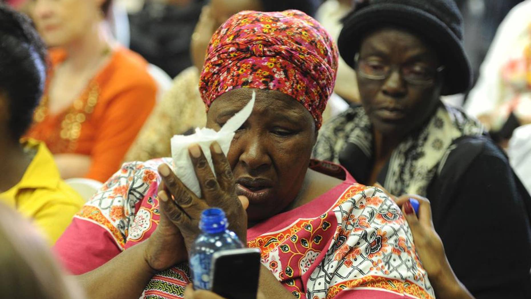 In this photo taken Wednesday, Feb 1, 2017 in Pretoria, South Africa's Bertha Molefe cries during an announcement of mentally ill patients who died after being transferred to non-governmental facilities allegedly operating with invalid licenses. Molefe's daughter, Sophia, was one of nearly 100 patients who died last year in South Africa's most developed province. (AP Photo)
