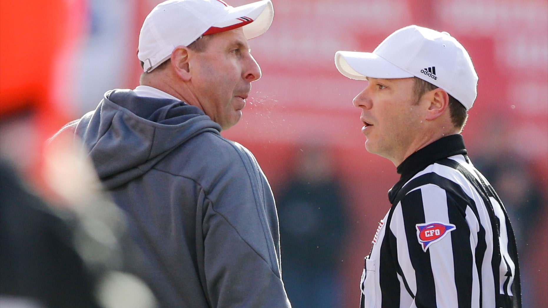 Nebraska head coach Bo Pelini, left, protests a pass interference call with referee Alex Kemp, right, in the third quarter of an NCAA college football game against Iowa in Lincoln, Neb., Friday, Nov. 29, 2013. Iowa won 38-17. (AP Photo/Nati Harnik)