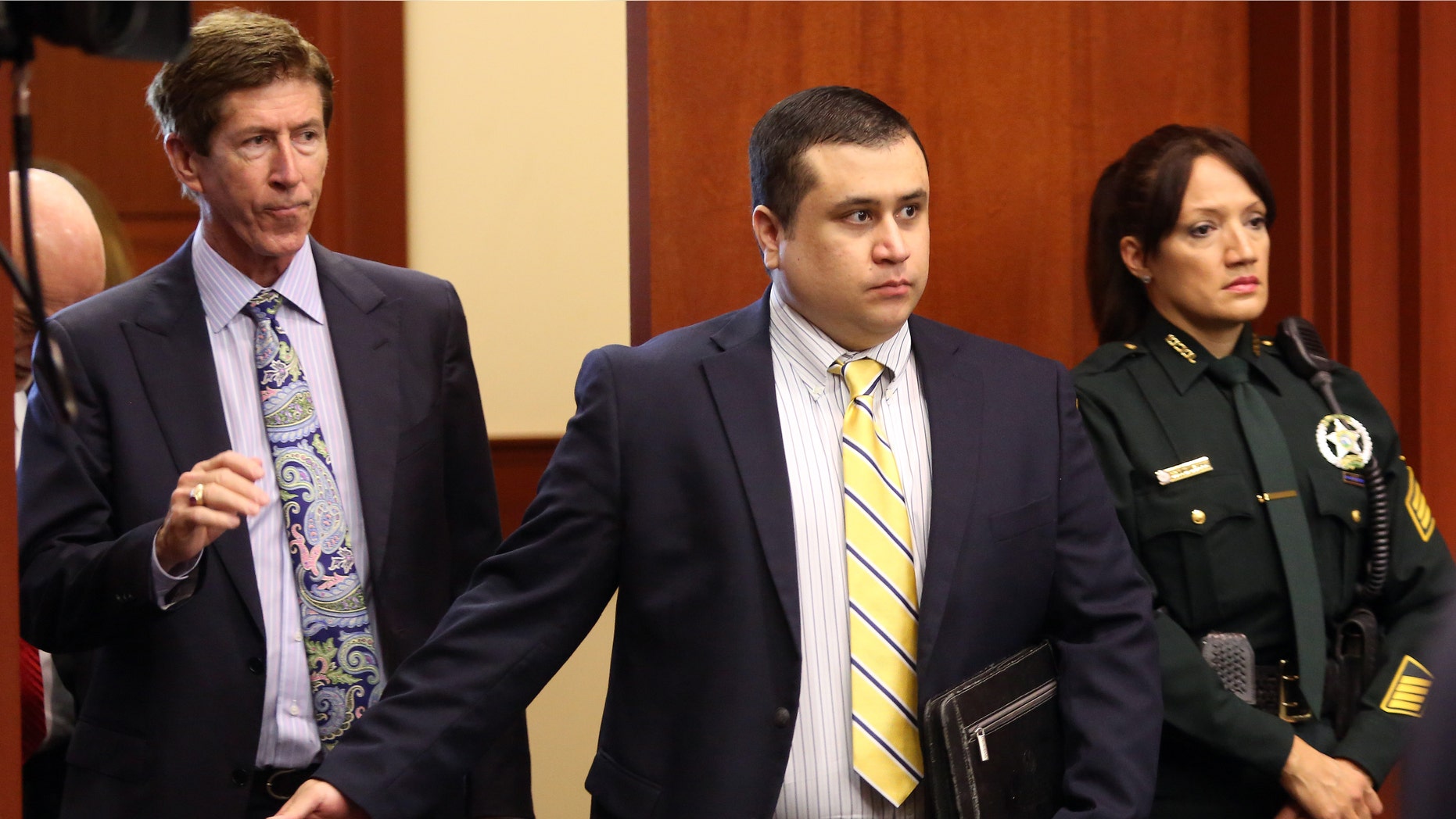 George Zimmerman, defendant in the killing of Trayvon Martin, arrives in Seminole circuit court, in Sanford, Fla., with his attorney Mark O'Mara, left, for a pre-trial hearing, Tuesday, April 30, 2013. State attorney Bernie de la Rionda is presenting a motion to the judge Tuesday during what will likely be the final lengthy hearing prior to George Zimmerman's second-degree murder trial in June. Zimmerman has pleaded not guilty. (AP Photo/Orlando Sentinel, Joe Burbank, Pool)