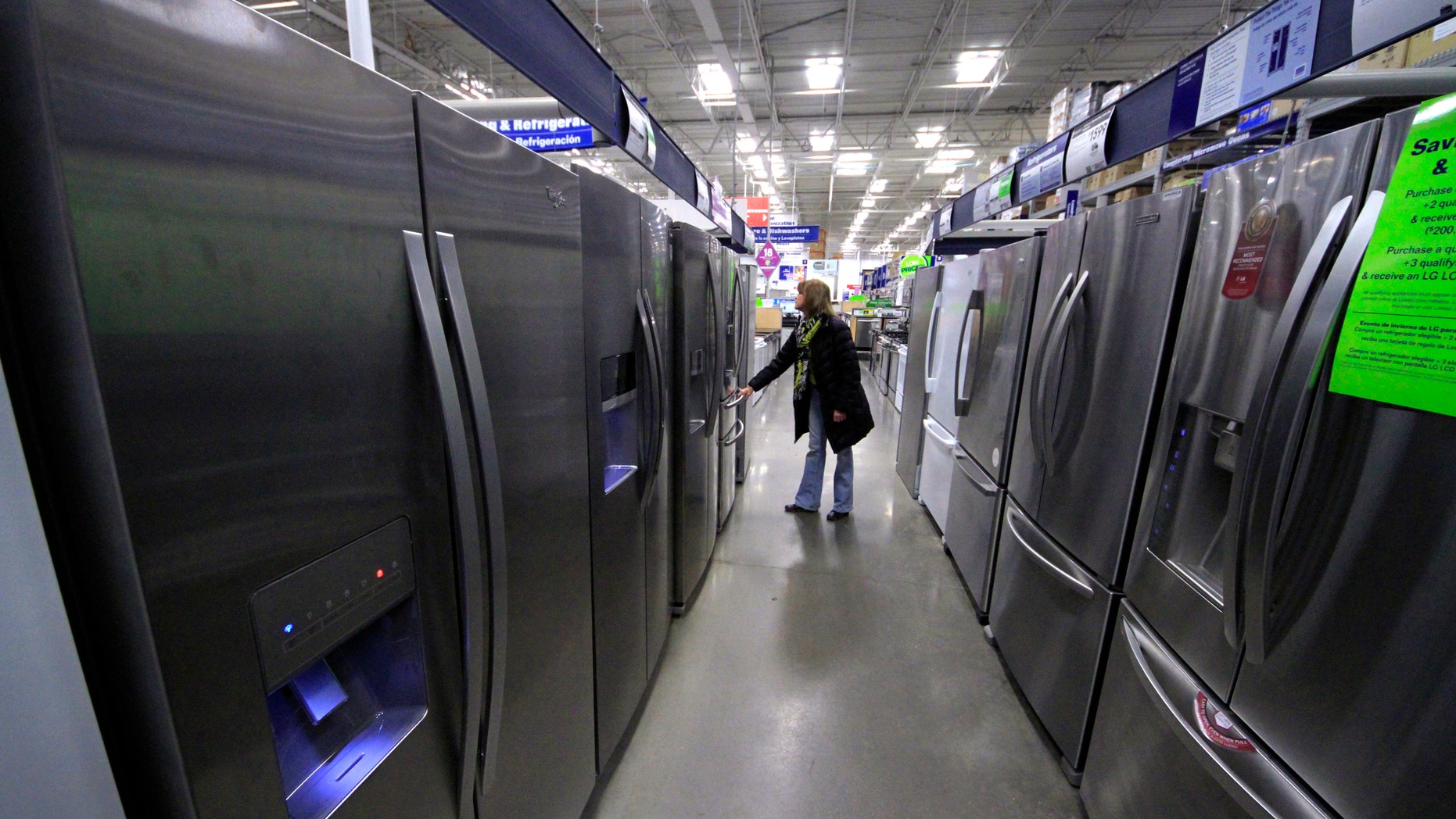 In this Thursday, Jan. 16, 2014, photo, a woman walks through a display of refrigerators at a Lowe's store in Cranberry Township, Pa. The Commerce Department releases durable goods for January on Thursday, Feb. 27, 2014. (AP Photo/Gene J. Puskar)
