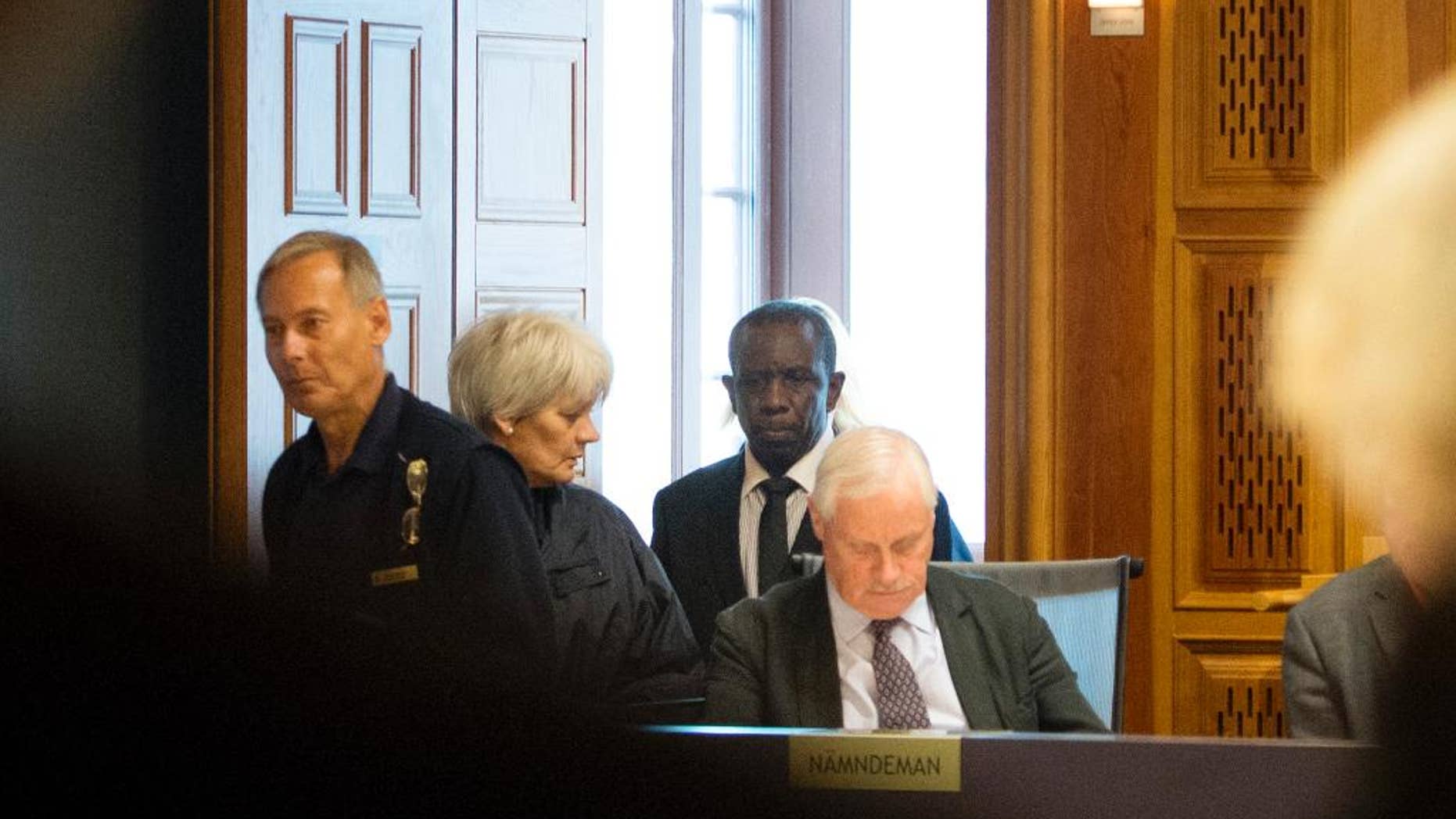 This is Sept. 16, 2015 file picture shows Claver Berinkindi, second from right a Swedish citizen originally from Rwanda. Claver Berinkindi on Monday May 16, 2016 was found guilty of genocide and gross violation of international law. The Stockholm district court said the 61-year-old was an informal low-level Hutu leader who took part in massacres of civilians in Muyira and Butare in southern Rwanda.. (Jessica Gow/TT via AP) SWEDEN OUT