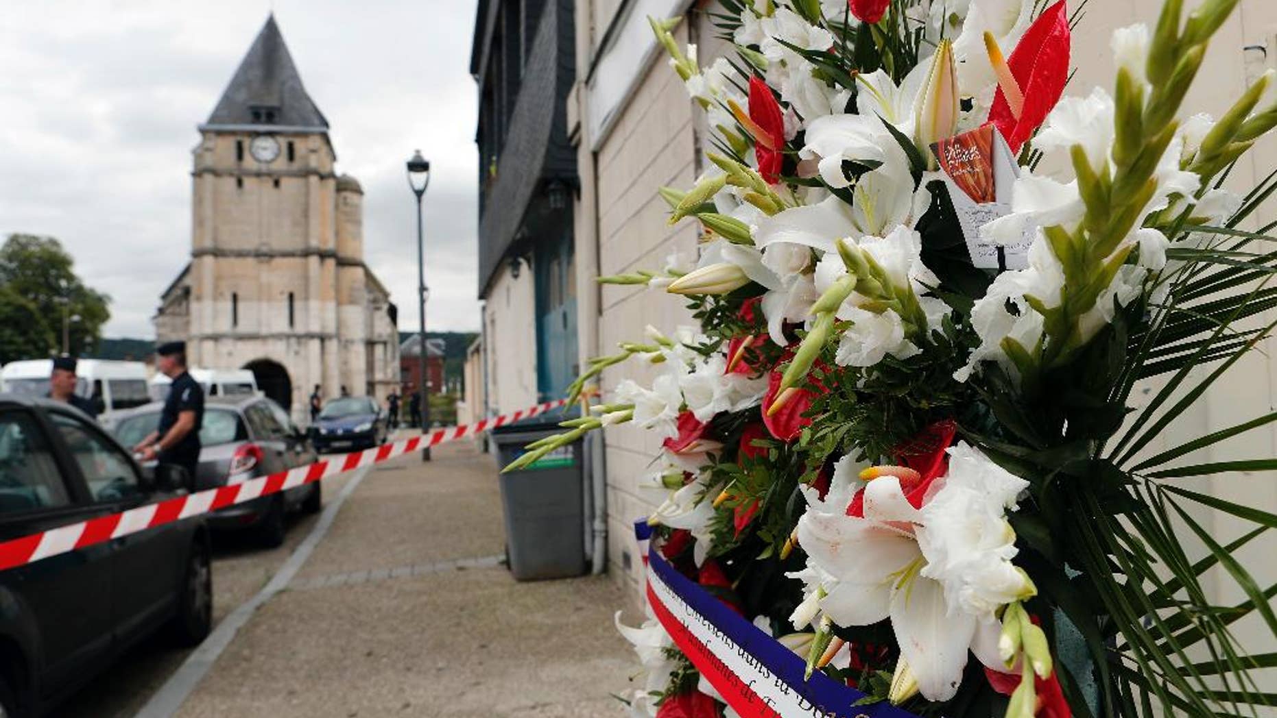 July 27, 2016: A wreath of flowers from the Muslims of France Association is placed outside the church where a priest was killed by Islamic terrorists in Saint-Etienne-du-Rouvray, Normandy, France.