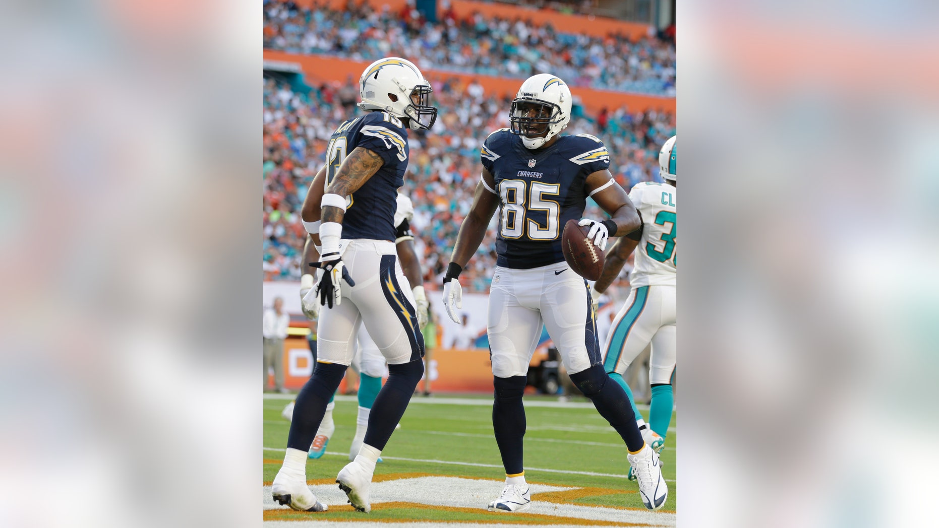 San Diego Chargers tight end Antonio Gates (85) is congratulated by wide receiver Keenan Allen (13) after scoring a touchdown during the first half of an NFL football game against the Miami Dolphins, Sunday, Nov. 17, 2013, in Miami Gardens, Fla. (AP Photo/Lynne Sladky)