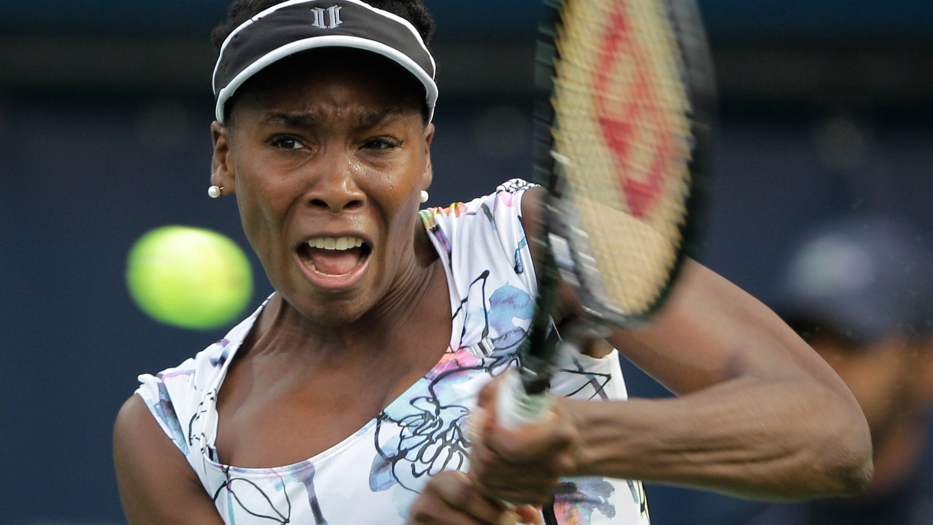 Venus Williams of the U.S. returns the ball to Ana Ivanovic of Serbia during the third day of Dubai Duty Free Tennis Championships in Dubai, United Arab Emirates, Wednesday, Feb. 19, 2014. (AP Photo/Kamran Jebreili)