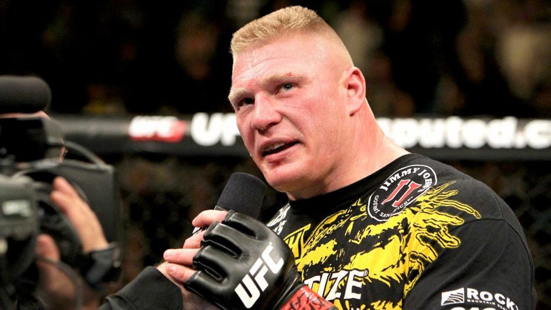 LAS VEGAS, NV - DECEMBER 30: Brock Lesnar announces his retirement in the Octagon after losing to Alistair Overeem during the UFC 141 event at the MGM Grand Garden Arena on December 30, 2011 in Las Vegas, Nevada. (Photo by Josh Hedges/Zuffa LLC/Zuffa LLC via Getty Images)