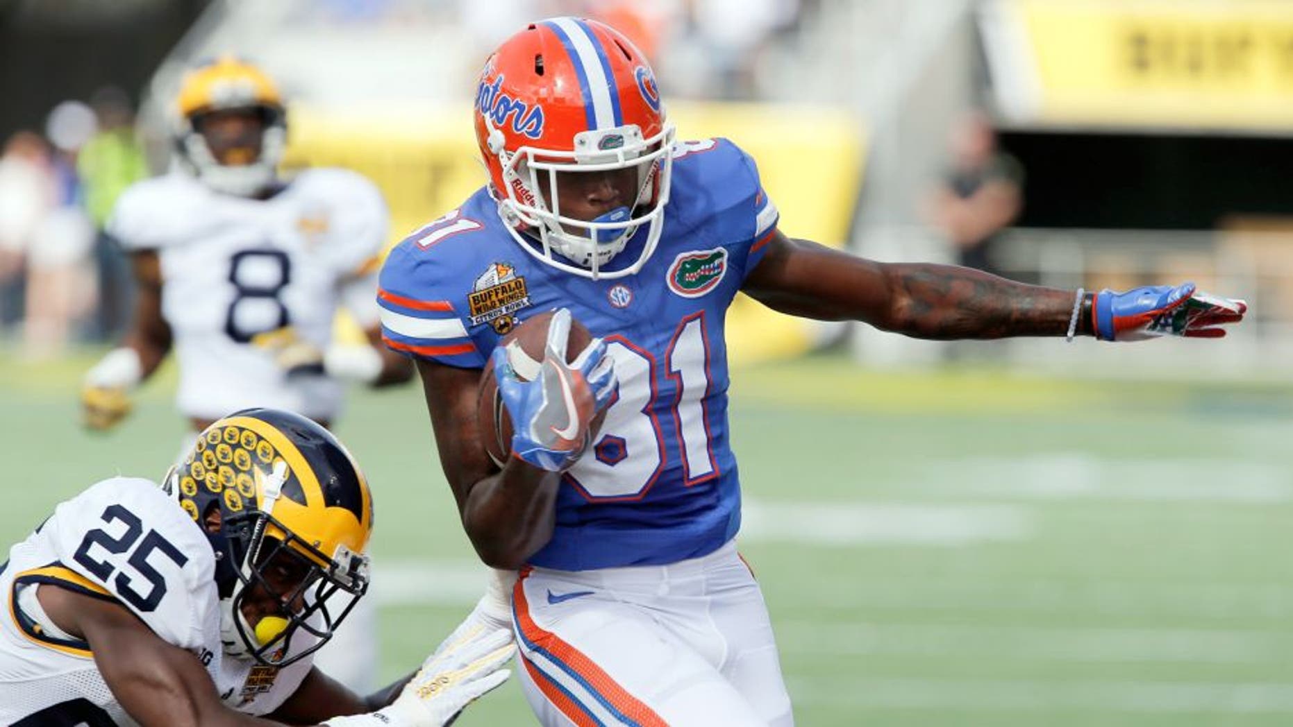 Jan 1, 2016; Orlando, FL, USA;Florida Gators wide receiver Antonio Callaway (81) runs around Michigan Wolverines safety Dymonte Thomas (25) during the first quarter in the 2016 Citrus Bowl at Orlando Citrus Bowl Stadium. Mandatory Credit: Reinhold Matay-USA TODAY Sports
