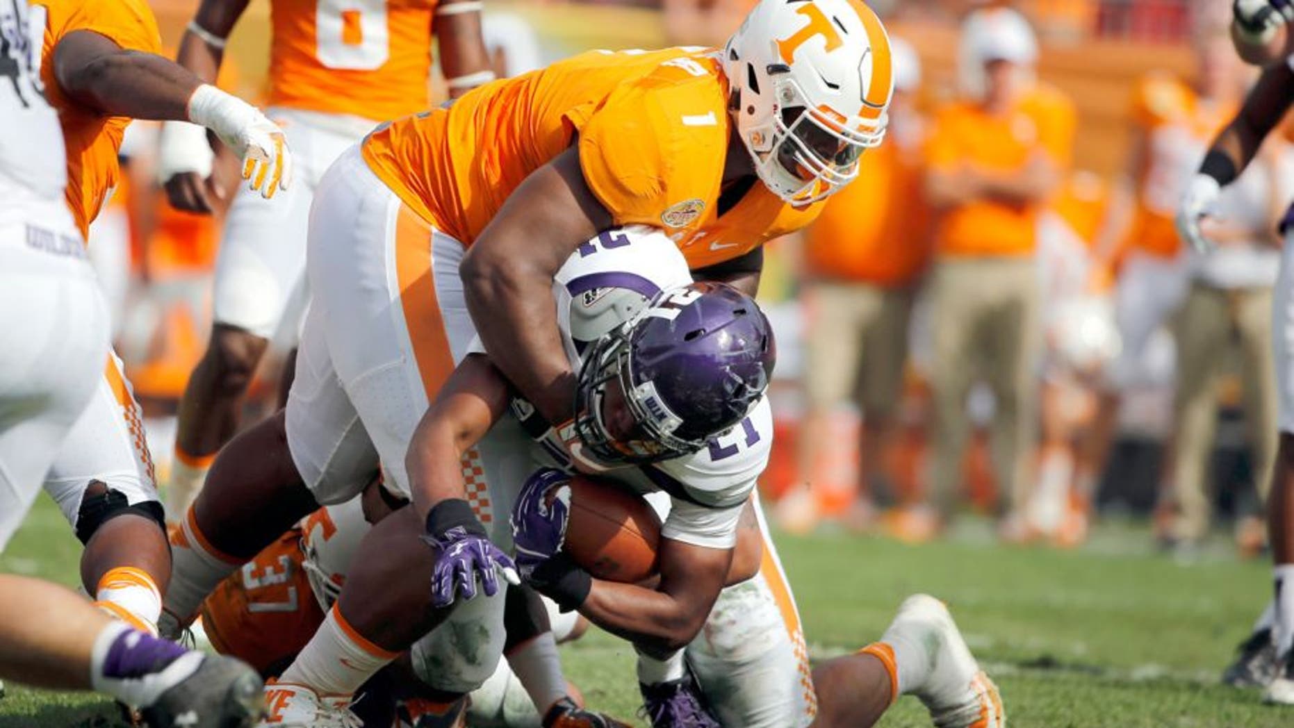 Jan 1, 2016; Tampa, FL, USA; Tennessee Volunteers defensive lineman Kahlil McKenzie (1) tackles Northwestern Wildcats running back Justin Jackson (21) during the first half in the 2016 Outback Bowl at Raymond James Stadium. Mandatory Credit: Kim Klement-USA TODAY Sports