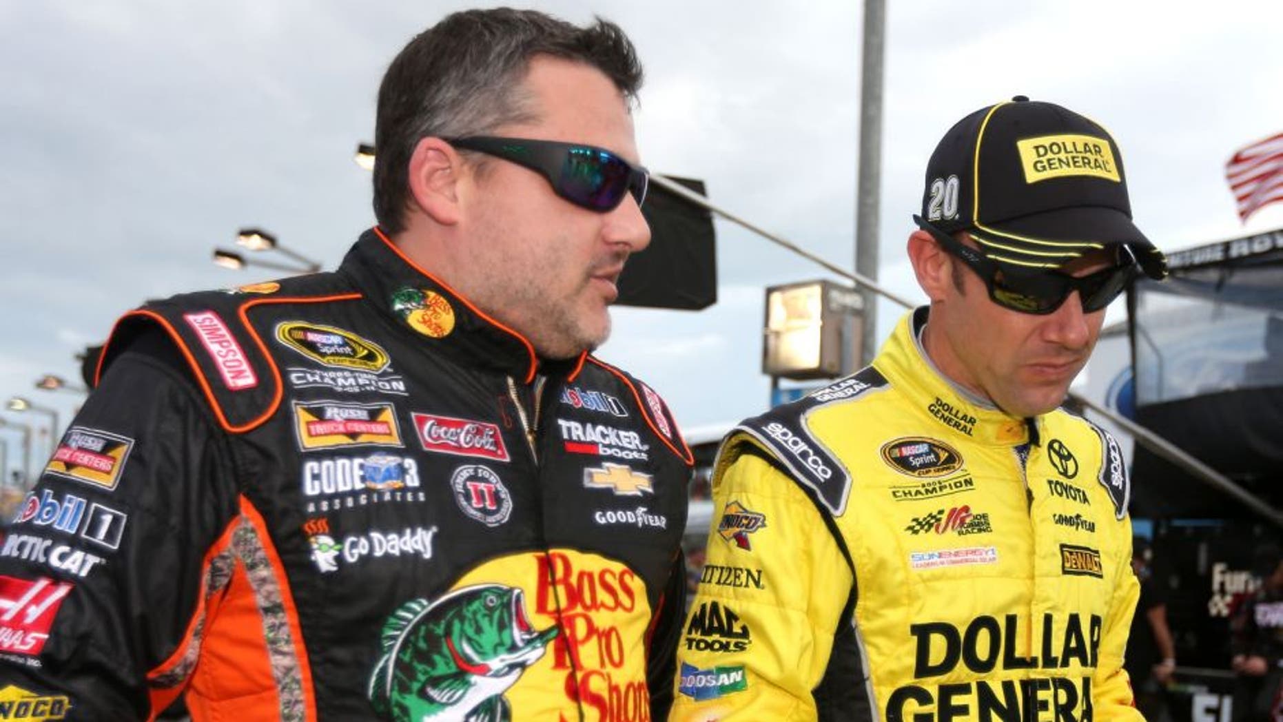 HOMESTEAD, FL - NOVEMBER 22: Tony Stewart, driver of the #14 Bass Pro Shops/Mobil 1 Chevrolet, talks to Matt Kenseth, driver of the #20 Dollar General Toyota, during the NASCAR Sprint Cup Series Ford EcoBoost 400 at Homestead-Miami Speedway on November 22, 2015 in Homestead, Florida. (Photo by Chris Graythen/Getty Images)