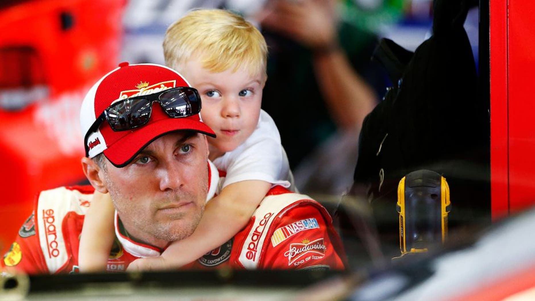 HOMESTEAD, FL - NOVEMBER 20: Kevin Harvick, driver of the #4 Budweiser/Jimmy John's Chevrolet, spends time with his son Keelan Harvick in the garage area during practice for the NASCAR Sprint Cup Series Ford EcoBoost 400 at Homestead-Miami Speedway on November 20, 2015 in Homestead, Florida. (Photo by Jonathan Ferrey/NASCAR via Getty Images)