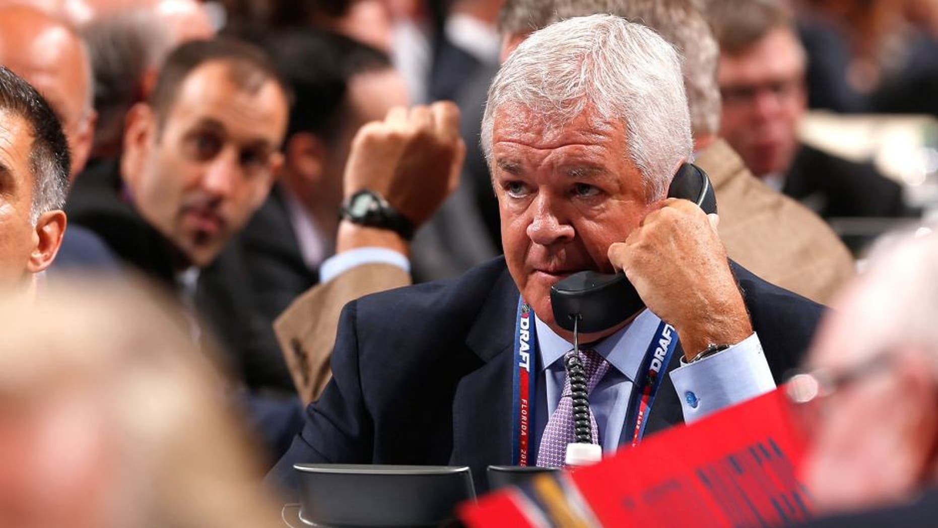 SUNRISE, FL - JUNE 26: General Manager Dale Tallon of the Florida Panthers talks on the phone at the draft table during Round One of the 2015 NHL Draft at BB&T Center on June 26, 2015 in Sunrise, Florida. (Photo by Eliot J. Schechter/NHLI via Getty Images)