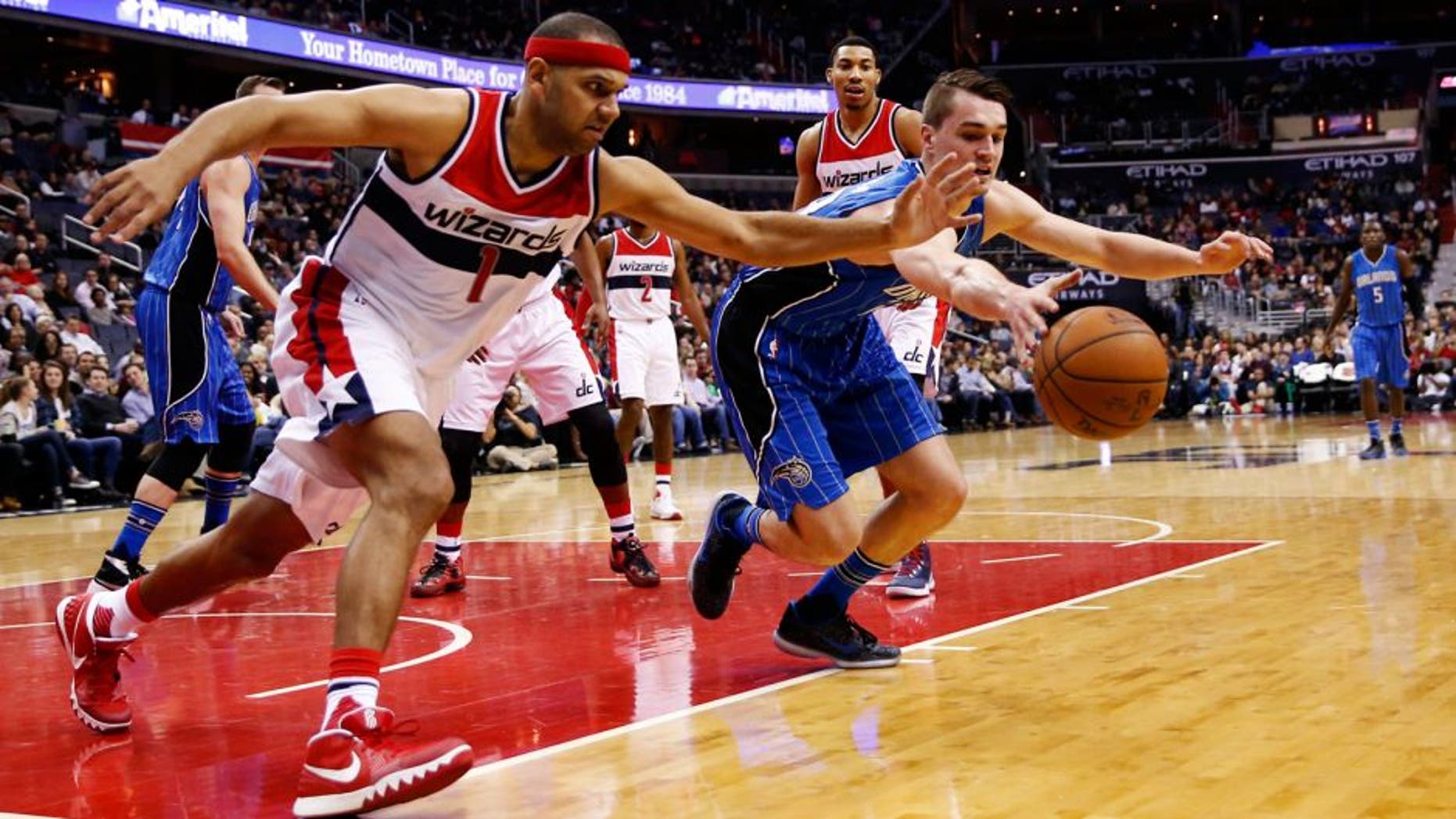 Washington Wizards forward Jared Dudley (1) and Orlando Magic guard Mario Hezonja (23), from Croatia, scramble for the rebound in the first half of an NBA basketball game, Friday, Jan. 1, 2016, in Washington. (AP Photo/Alex Brandon)