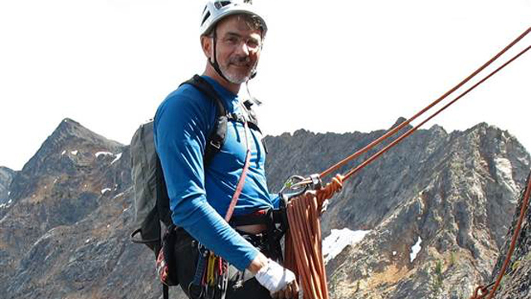 Doug Walker is pictured mountain climbing.