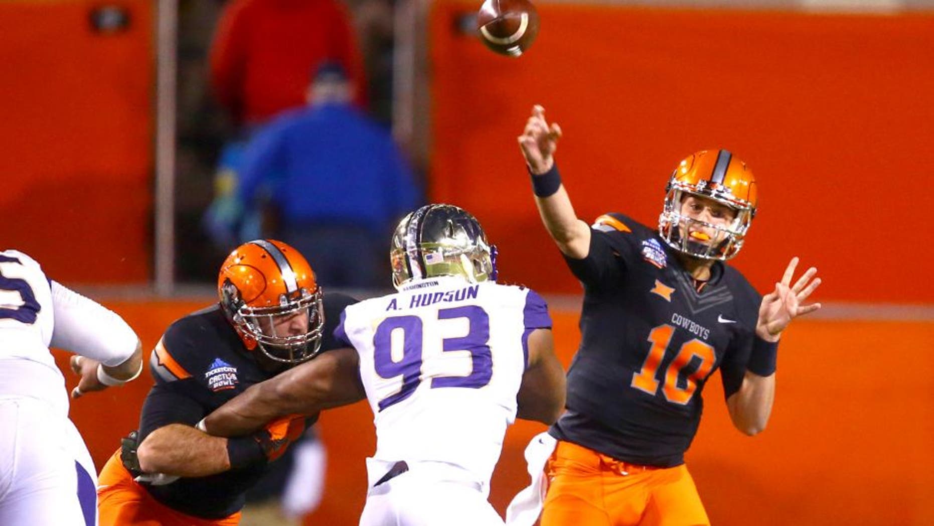 Jan 2, 2015; Tempe, AZ, USA; Oklahoma State Cowboys quarterback Mason Rudolph (10) throws a pass in the first quarter against the Washington Huskies in the 2015 Cactus Bowl at Sun Devil Stadium. Mandatory Credit: Mark J. Rebilas-USA TODAY Sports