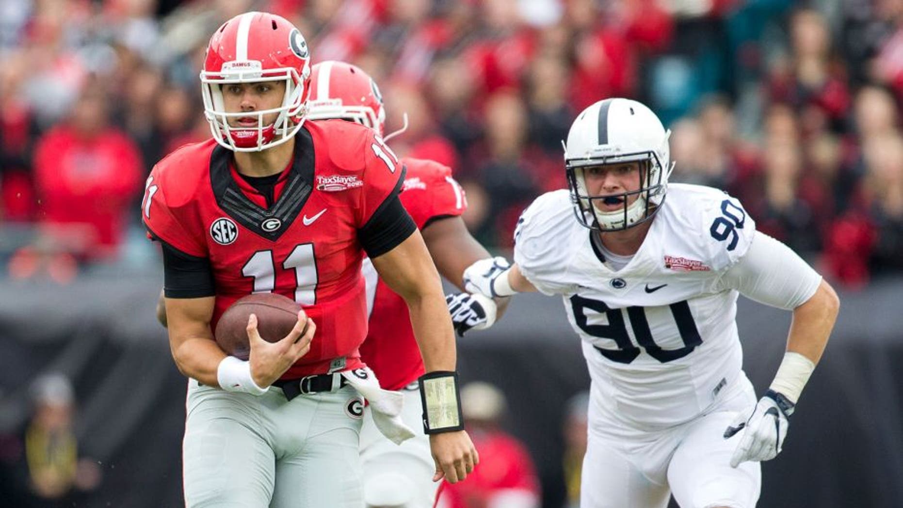 Jan 2, 2016; Jacksonville, FL, USA; Georgia Bulldogs quarterback Greyson Lambert (11) runs with the football during the first quarter against the Penn State Nittany Lions at EverBank Field. Mandatory Credit: Logan Bowles-USA TODAY Sports