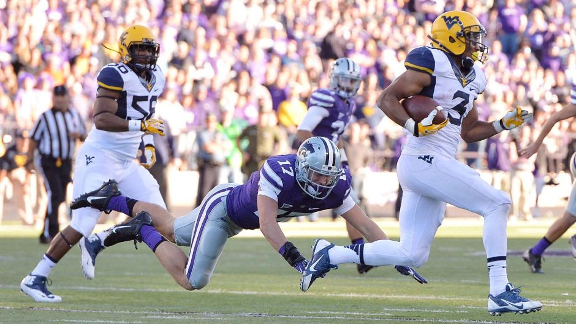 Oct 26, 2013; Manhattan, KS, USA; Kansas State Wildcats defensive back Weston Hiebert (17) misses a tackle on West Virginia Mountaineers running back Charles Sims (3) during the second half at Bill Snyder Family Stadium. The Wildcats defeat the Mountaineers 35-12. Mandatory Credit: Jasen Vinlove-USA TODAY Sports