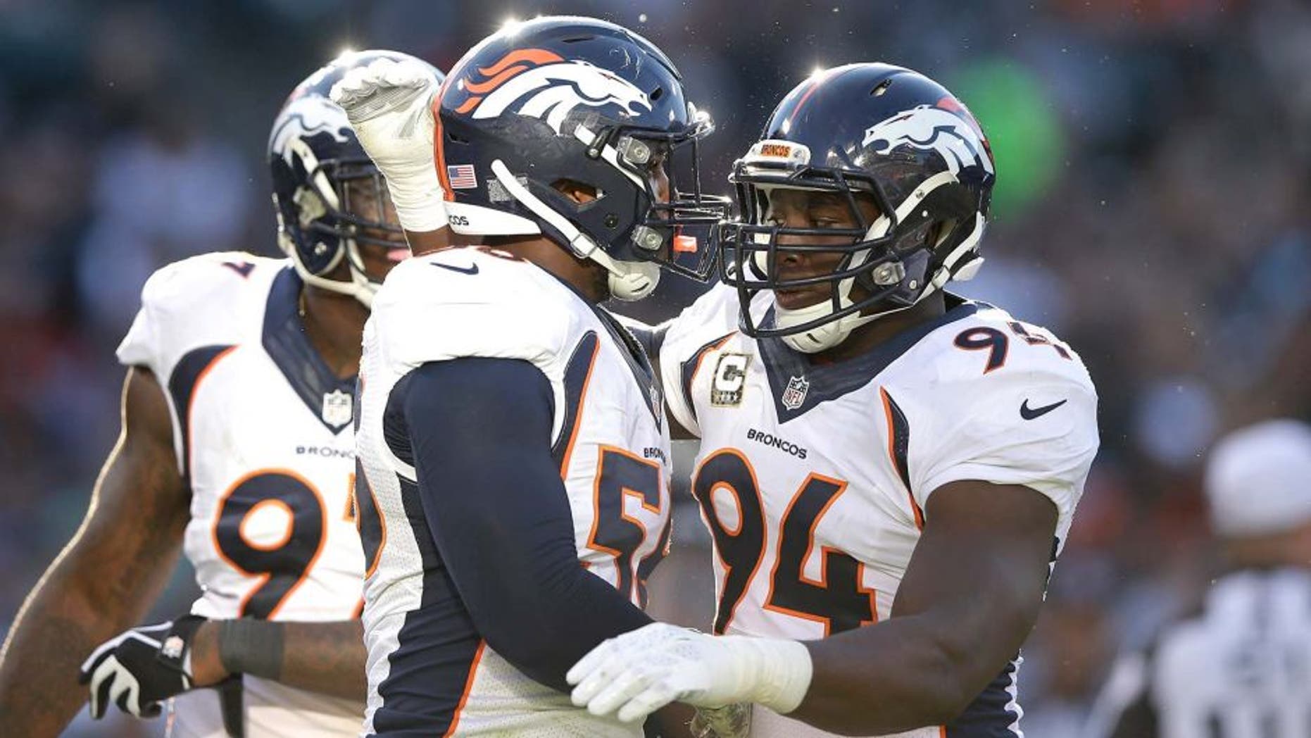 OAKLAND, CA - NOVEMBER 09: DeMarcus Ware #94 of the Denver Broncos celebrates with teammate Von Miller #58 in the third quarter against the Oakland Raiders at O.co Coliseum on November 9, 2014 in Oakland, California. (Photo by Ezra Shaw/Getty Images)