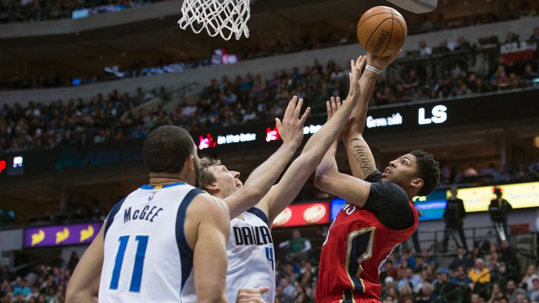 Jan 2, 2016; Dallas, TX, USA; New Orleans Pelicans forward Anthony Davis (23) shoots over Dallas Mavericks forward Dirk Nowitzki (41) and center JaVale McGee (11) during the second half at the American Airlines Center. The Pelicans defeat the Mavericks 105-98. Mandatory Credit: Jerome Miron-USA TODAY Sports