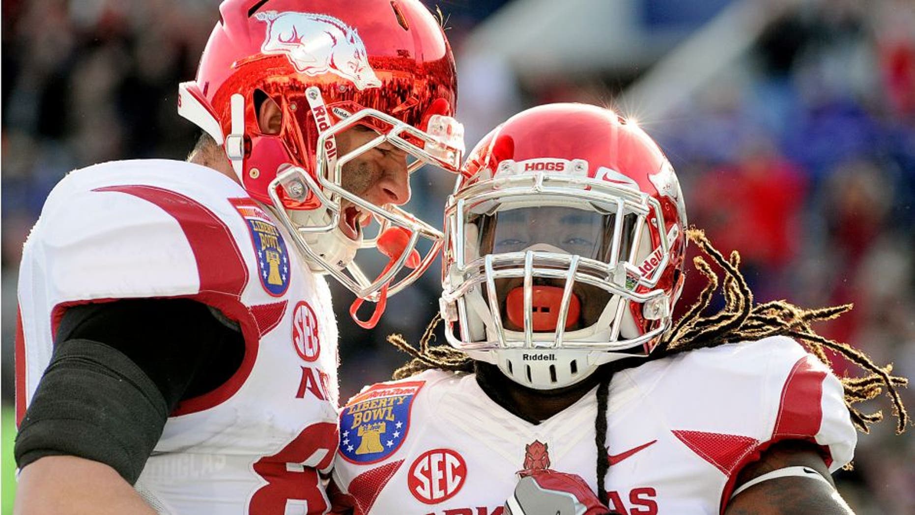 Jan 2, 2016; Memphis, TN, USA; Arkansas Razorbacks running back Alex Collins (3) and Arkansas Razorbacks tight end Jeremy Sprinkle (83) celebrate a touchdown during the first half against the Kansas State Wildcats at Liberty Bowl. Mandatory Credit: Justin Ford-USA TODAY Sports