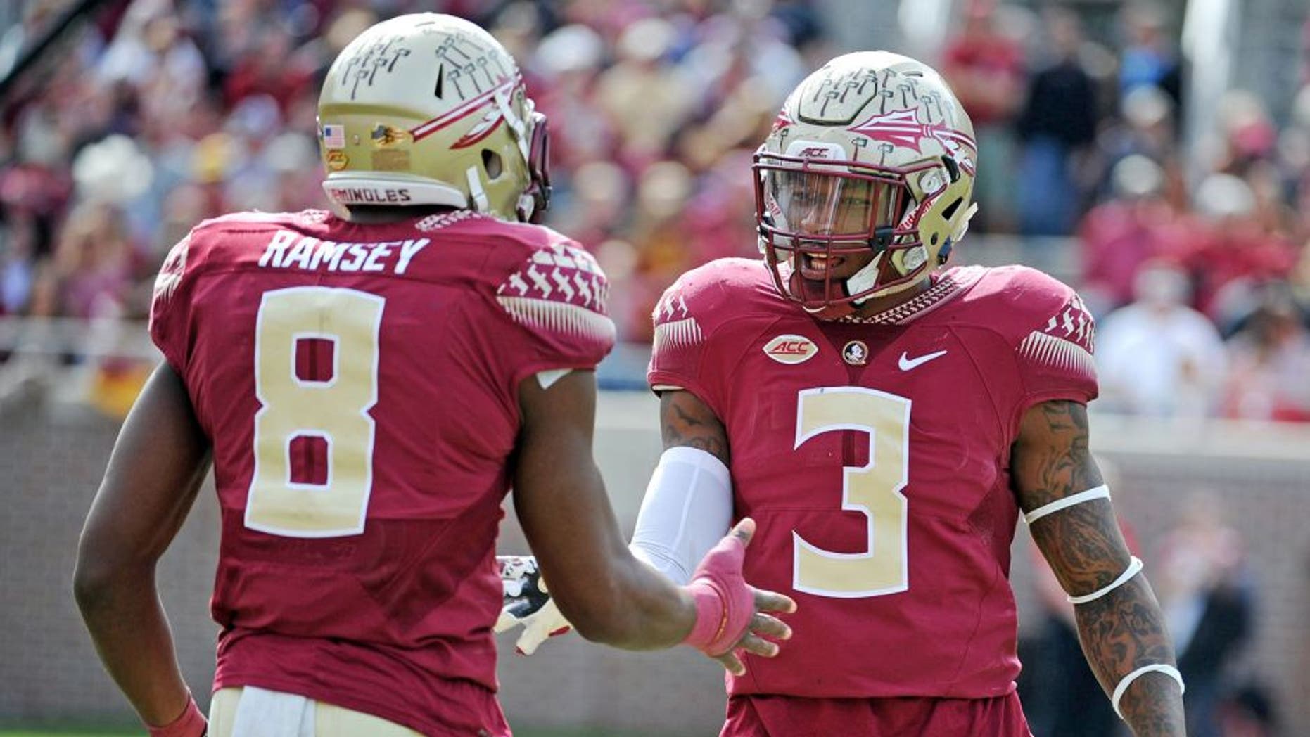 Nov 14, 2015; Tallahassee, FL, USA; Florida State University defensive back Jalen Ramsey (8) celebrates with defensive back Derwin James (3) after a defensive stop during the game against the North Carolina State Wolfpack at Doak Campbell Stadium. Mandatory Credit: Melina Vastola-USA TODAY Sports
