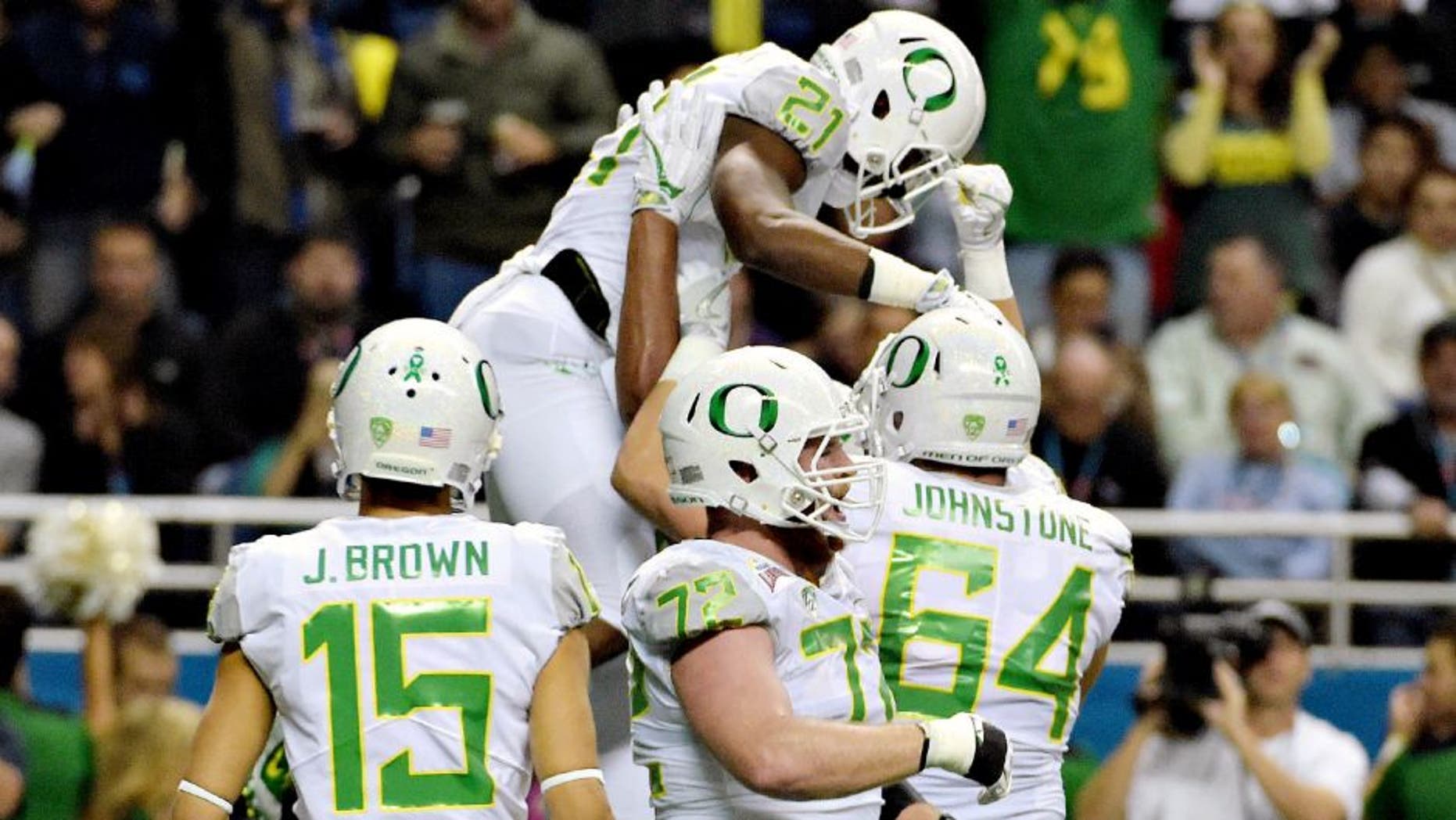 Jan 2, 2016; San Antonio, TX, USA; Oregon Ducks running back Royce Freeman (21) is hoisted by teammates after scoring on a 4-yard touchdown run against the TCU Horned Frogs during the 2016 Alamo Bowl at Alamodome. Mandatory Credit: Kirby Lee-USA TODAY Sports