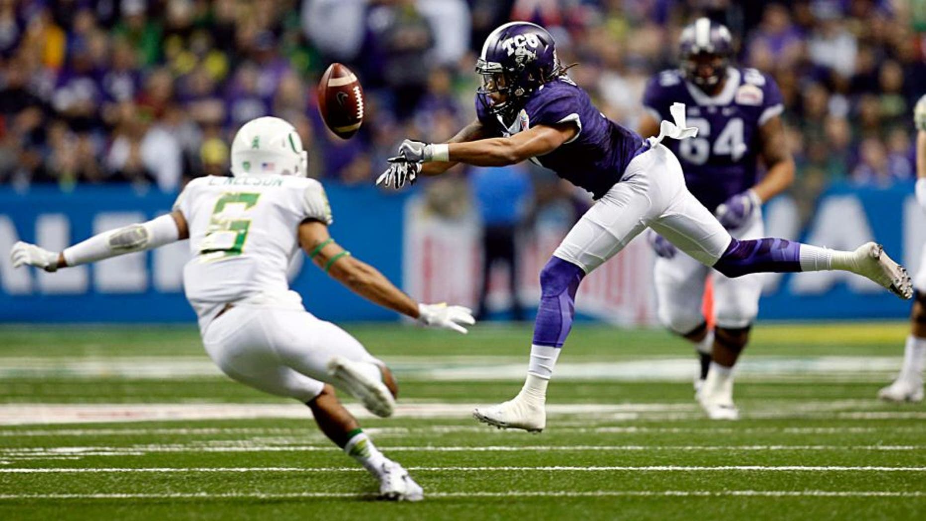 Jan 2, 2016; San Antonio, TX, USA; TCU Horned Frogs wide receiver Kolby Listenbee (7) misses a catch as Oregon Ducks safety Charles Nelson (6) defends in the 2016 Alamo Bowl at the Alamodome. Mandatory Credit: Erich Schlegel-USA TODAY Sports