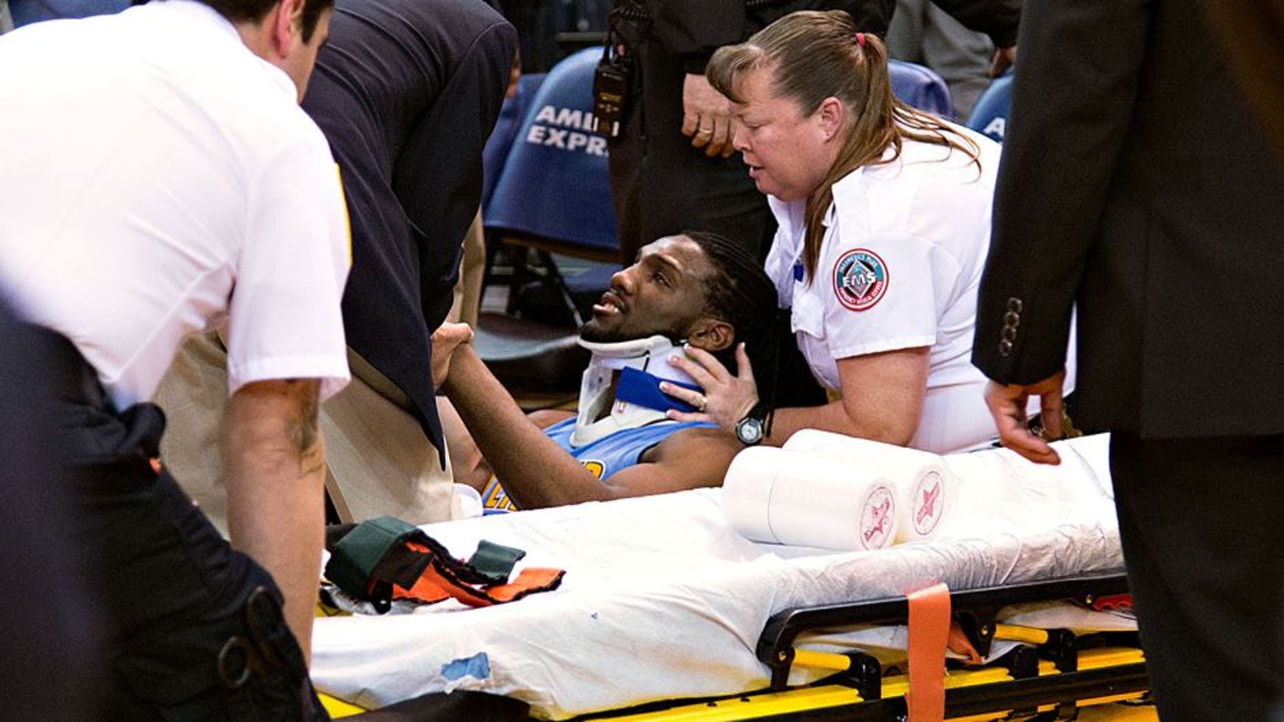 January 2, 2016; Oakland, CA, USA; Denver Nuggets forward Kenneth Faried (35) receives medical attention after the game against the Golden State Warriors at Oracle Arena. The Warriors defeated the Nuggets 111-108 in overtime. Mandatory Credit: Kyle Terada-USA TODAY Sports