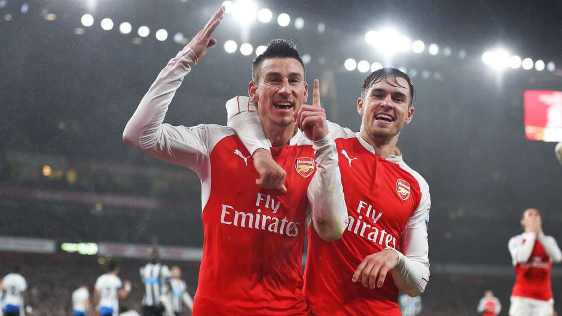 LONDON, ENGLAND - JANUARY 02: Laurent Koscielny (L) of Arsenal celebrates scoring his team's first goal with his team mate Aaron Ramsey (R) during the Barclays Premier League match between Arsenal and Newcastle United at Emirates Stadium on January 2, 2016 in London, England. (Photo by Shaun Botterill/Getty Images)