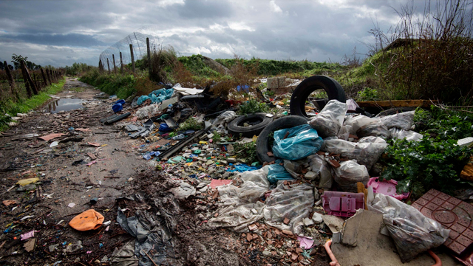 FILE -- In this Nov. 18, 2013 photo, rubbish is piled up on the edge of cultivated land near Caivano, in the surroundings of Naples, southern Italy.