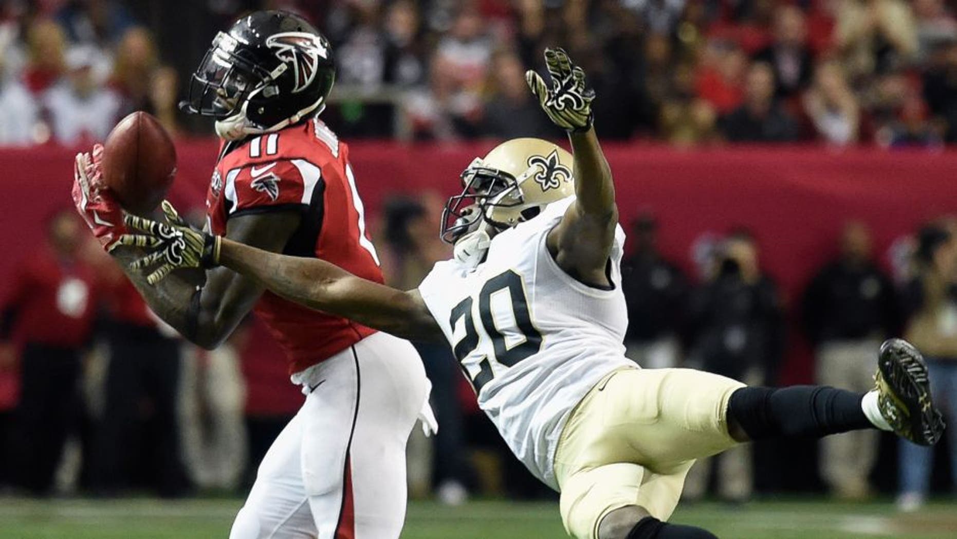 Jan 3, 2016; Atlanta, GA, USA; Atlanta Falcons wide receiver Julio Jones (11) catches a pass defended by New Orleans Saints defensive back Brian Dixon (20) during the fourth quarter at the Georgia Dome. The Saints defeated the Falcons 20-17. Mandatory Credit: Dale Zanine-USA TODAY Sports