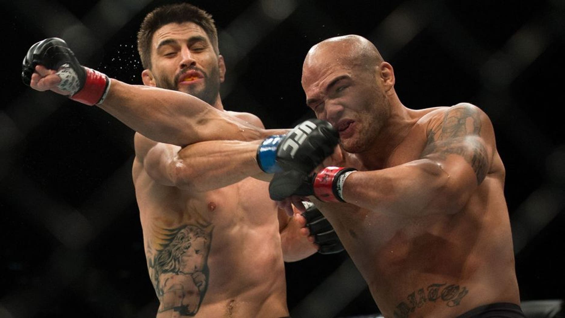 LAS VEGAS, NV - JANUARY 02: (R-L) Robbie Lawler exchanges punches with Carlos Condit in their welterweight championship fight during the UFC 195 event inside MGM Grand Garden Arena on January 2, 2016 in Las Vegas, Nevada. (Photo by Brandon Magnus/Zuffa LLC/Zuffa LLC via Getty Images)
