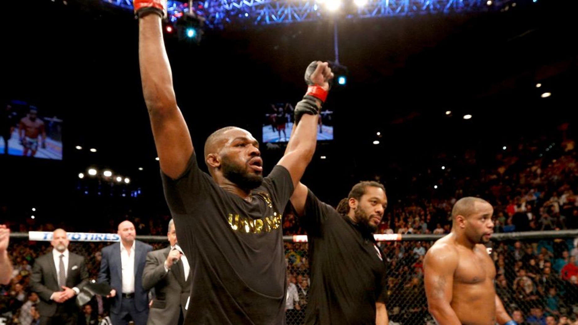 LAS VEGAS, NV - JANUARY 03: UFC light heavyweight champion Jon Jones (L) celebrates his win over Daniel Cormier (R) in their UFC light heavyweight championship bout during the UFC 182 event at the MGM Grand Garden Arena on January 3, 2015 in Las Vegas, Nevada. (Photo by Josh Hedges/Zuffa LLC/Zuffa LLC via Getty Images)
