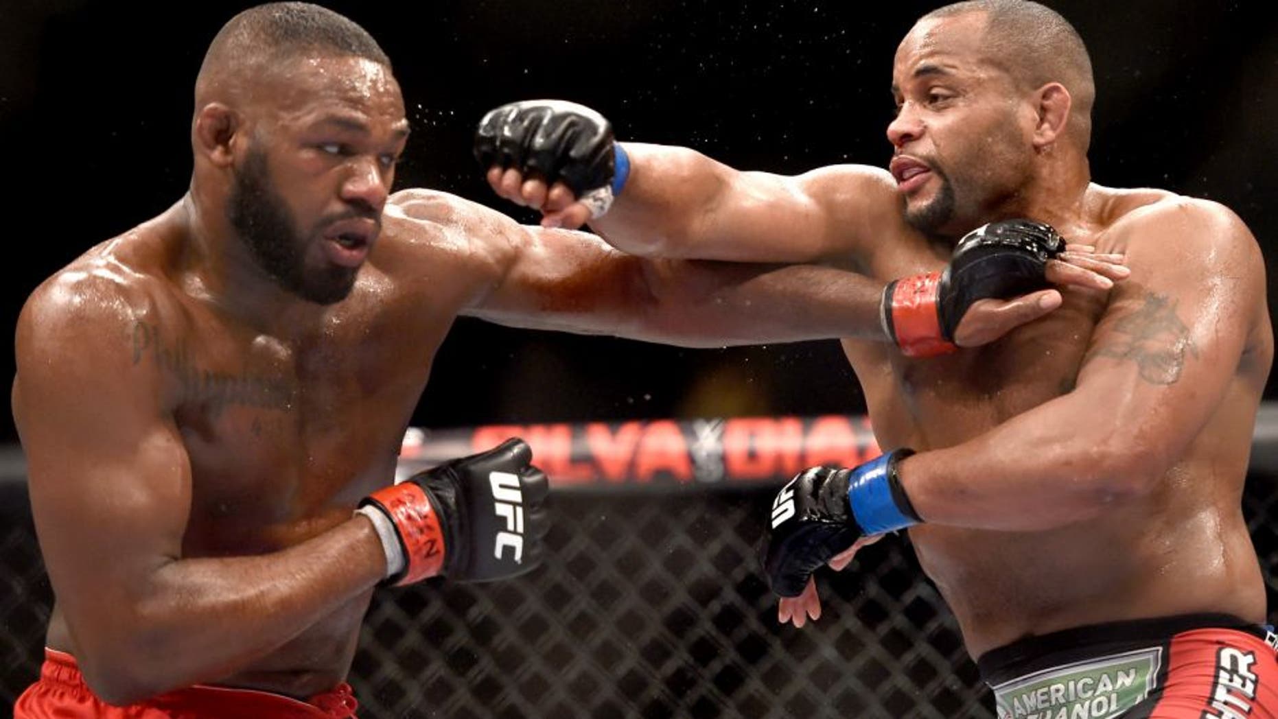 LAS VEGAS, NV - JANUARY 03: Jon Jones (L) and Daniel Cormier (R) exchange punches in their UFC light heavyweight championship bout during the UFC 182 event at the MGM Grand Garden Arena on January 3, 2015 in Las Vegas, Nevada. (Photo by Jeff Bottari/Zuffa LLC/Zuffa LLC via Getty Images)