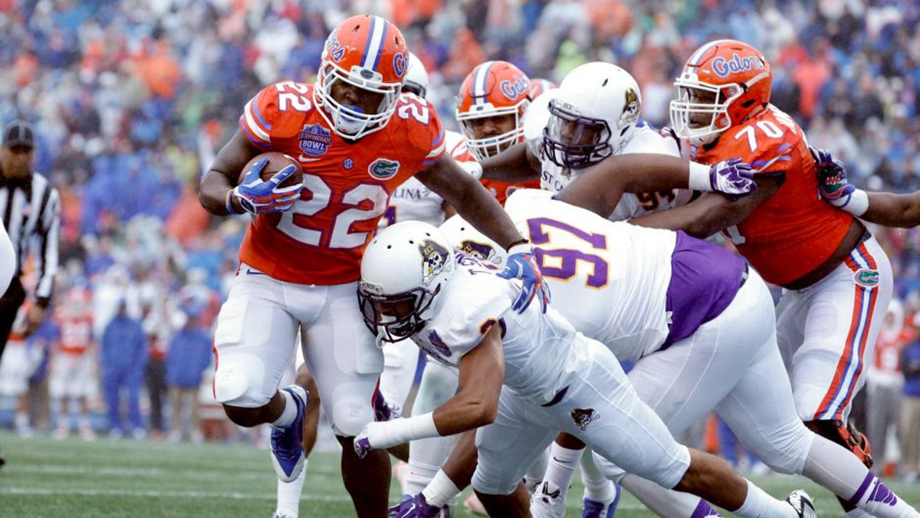 Jan 3, 2015; Birmingham, AL, USA; Florida Gators running back Adam Lane (22) is hit by East Carolina Pirates defensive back Travon Simmons (3) as he scores a touchdown during the Birmingham Bowl at Legion Field. Mandatory Credit: Marvin Gentry-USA TODAY Sports