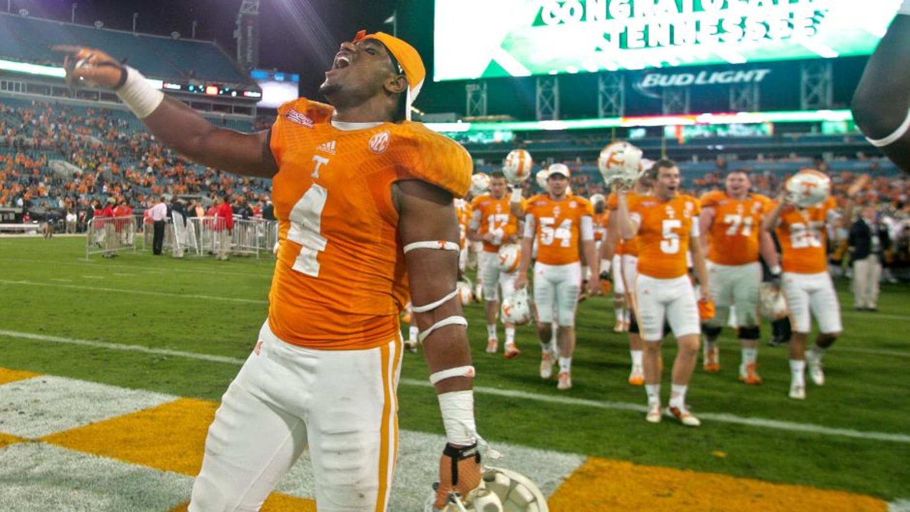 Jan 2, 2015; Jacksonville, FL, USA; Tennessee Volunteers defensive lineman LaTroy Lewis (4) celebrates after their 2015 TaxSlayer Bowl game against the Iowa Hawkeyes at EverBank Field. The Tennessee Volunteers beat the Iowa Hawkeyes 45-28. Mandatory Credit: Phil Sears-USA TODAY Sports