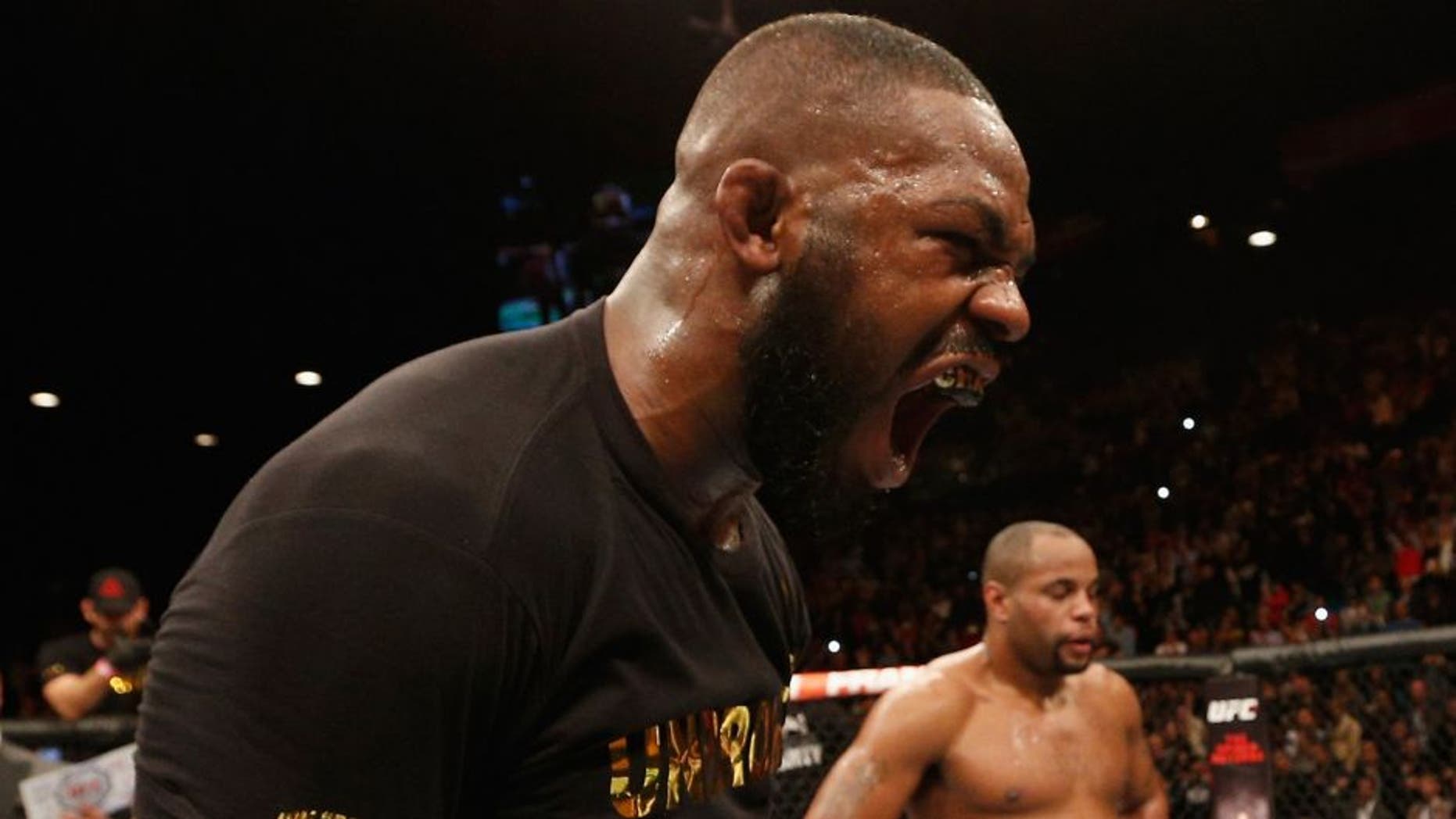 LAS VEGAS, NV - JANUARY 03: UFC light heavyweight champion Jon Jones (L) celebrates his win over Daniel Cormier (R) in their UFC light heavyweight championship bout during the UFC 182 event at the MGM Grand Garden Arena on January 3, 2015 in Las Vegas, Nevada. (Photo by Josh Hedges/Zuffa LLC/Zuffa LLC via Getty Images)